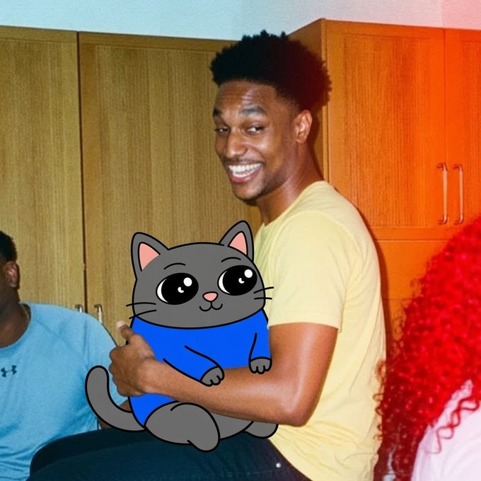 Someone holding Smol Cat like a plushie
